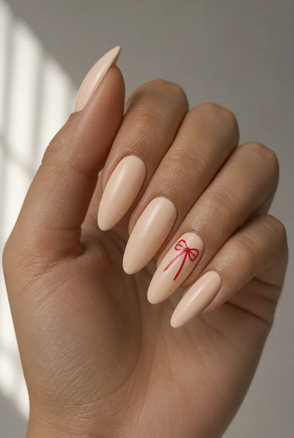 bow accent nail art on olive skin, long length