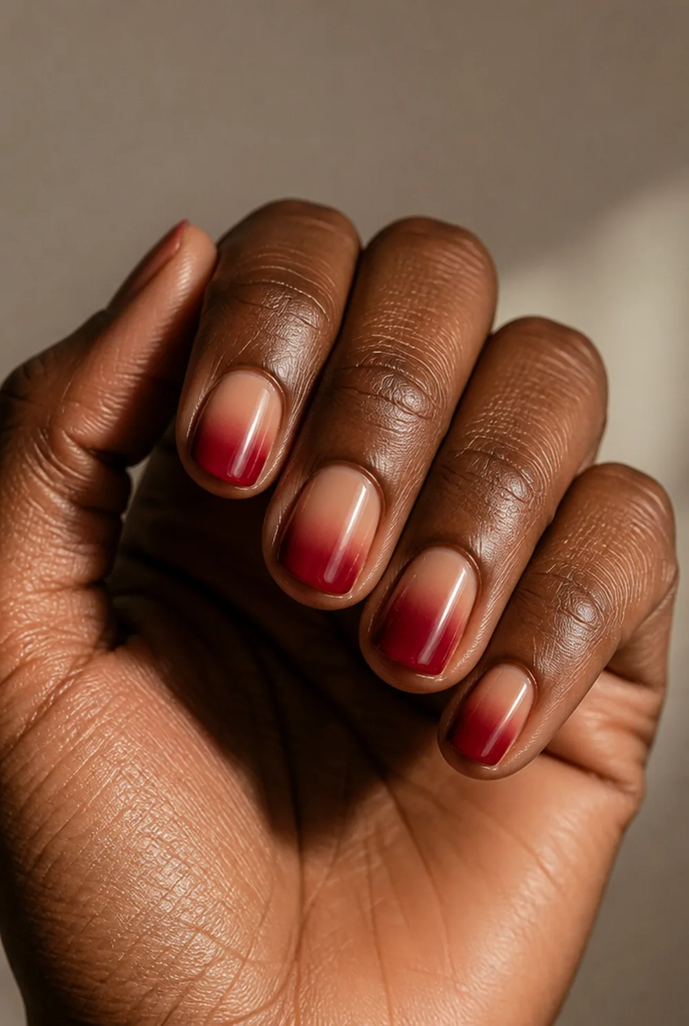 red ombre fade nail art on deep brown skin