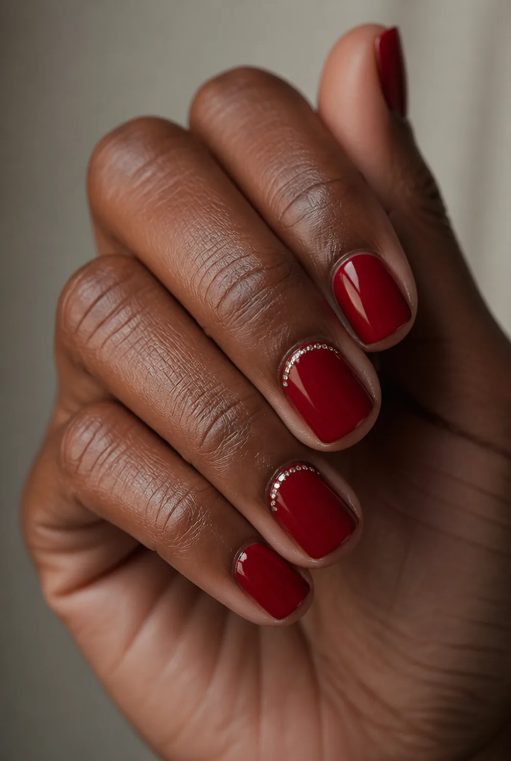 red with rhinestone cuff nail art on deep brown skin