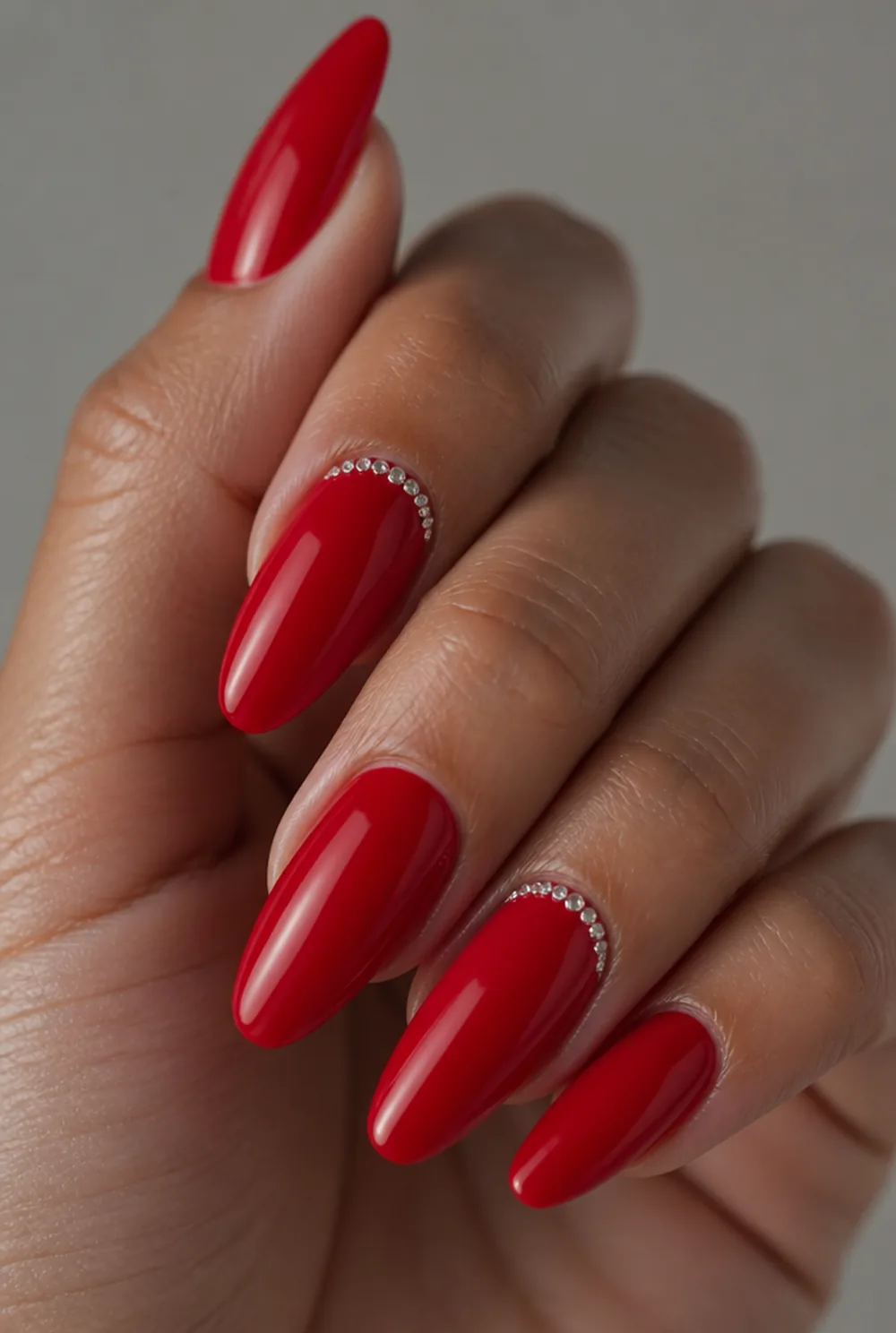 red with rhinestone cuff nail art on olive skin, long length