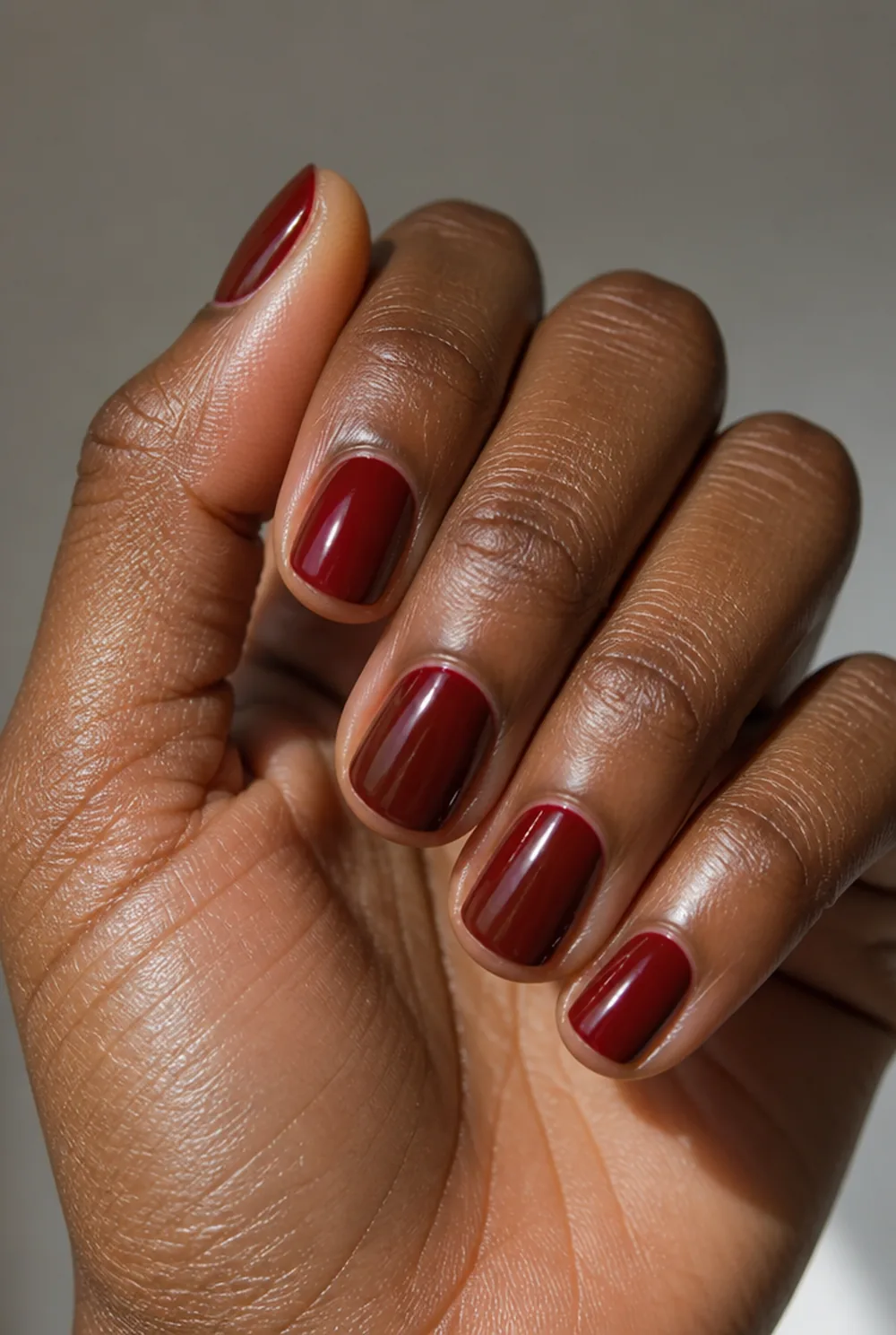 blackened cherry nail art on deep brown skin