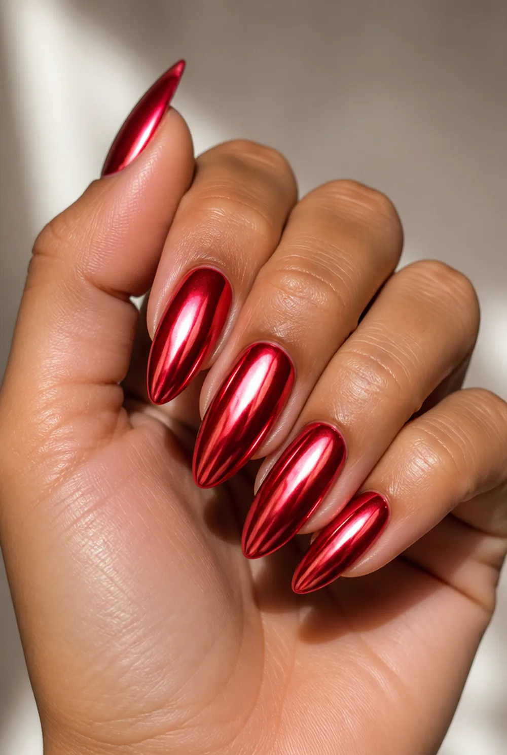 red chrome mirror nail art on olive skin, long length