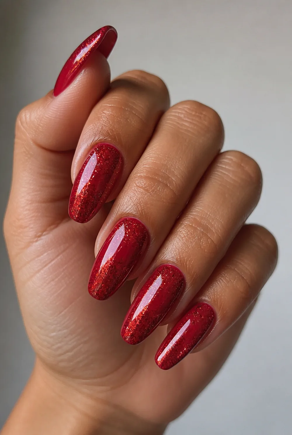 red glitter ombre nail art on olive skin, long length