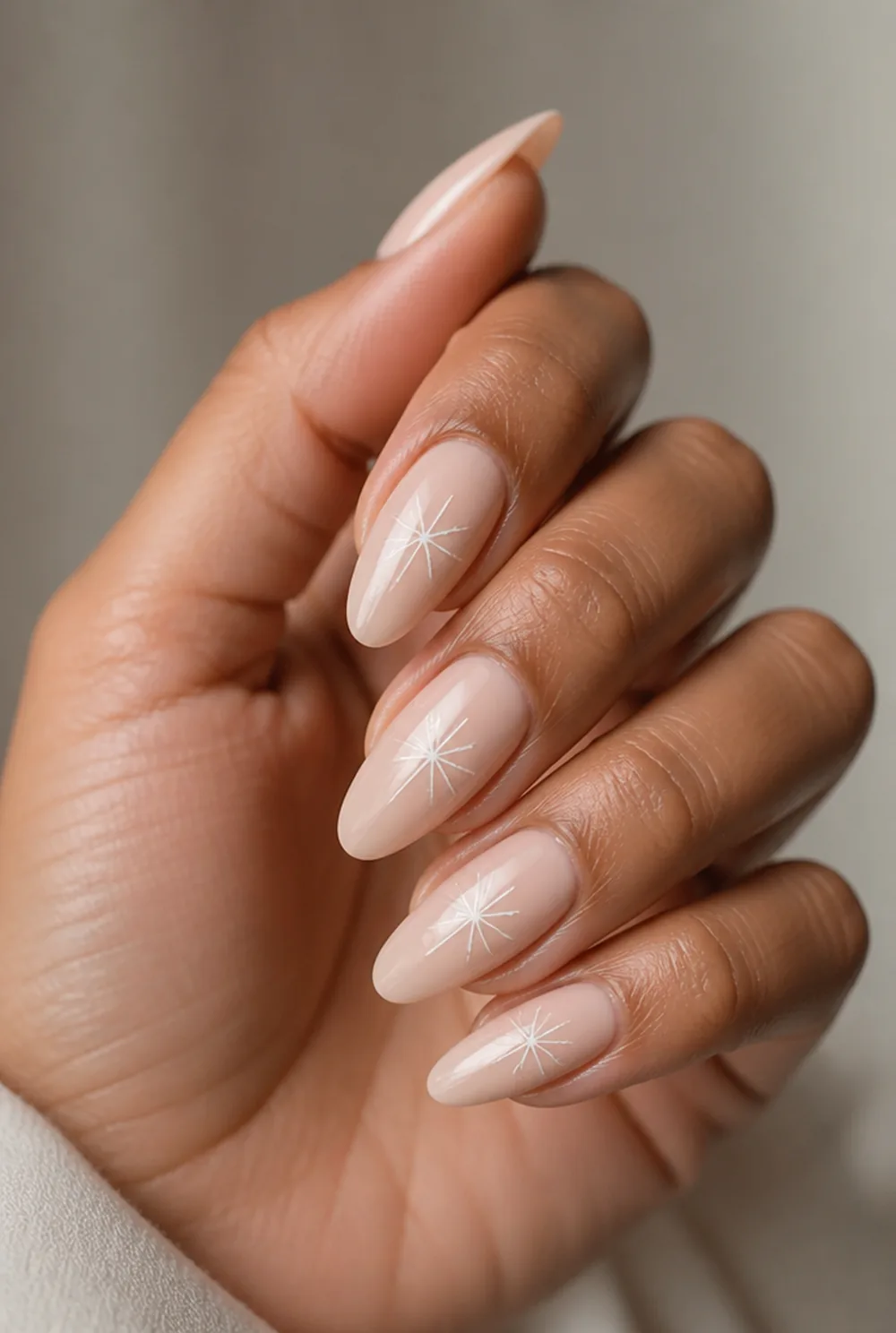 minimalist three-stroke flake nail art on olive skin, long length