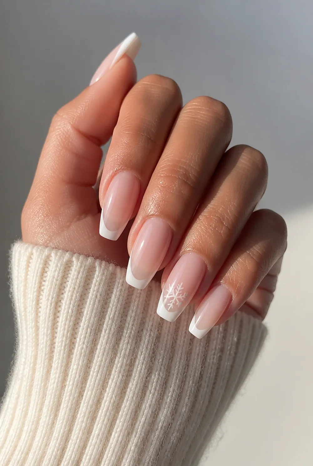 snowflake french tip nail art on olive skin, long length