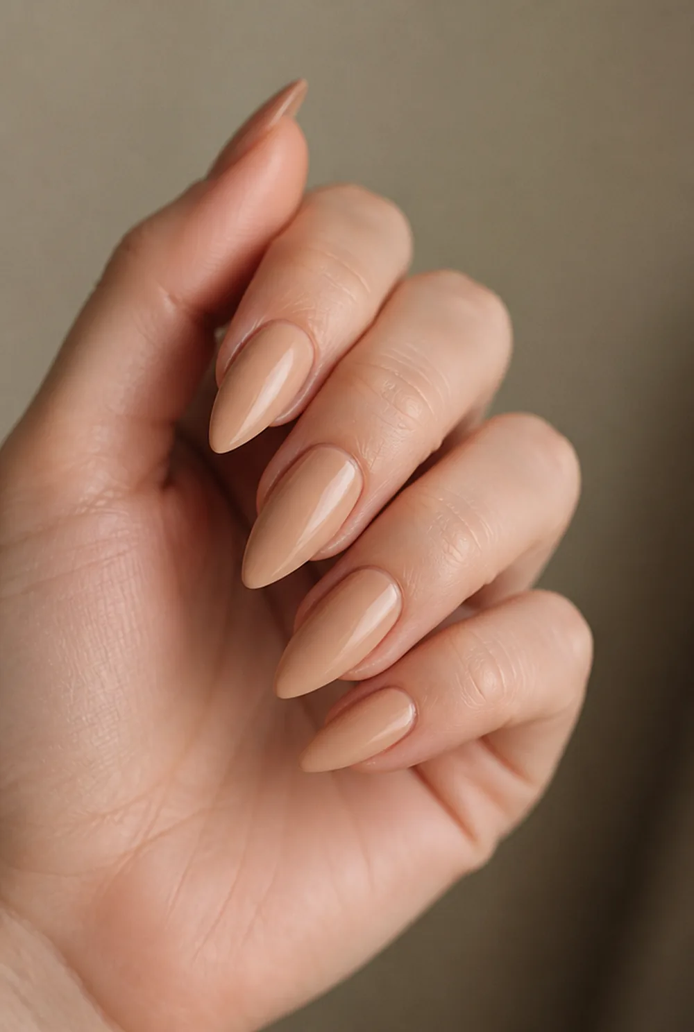 long nude stiletto nail art on fair skin, short length