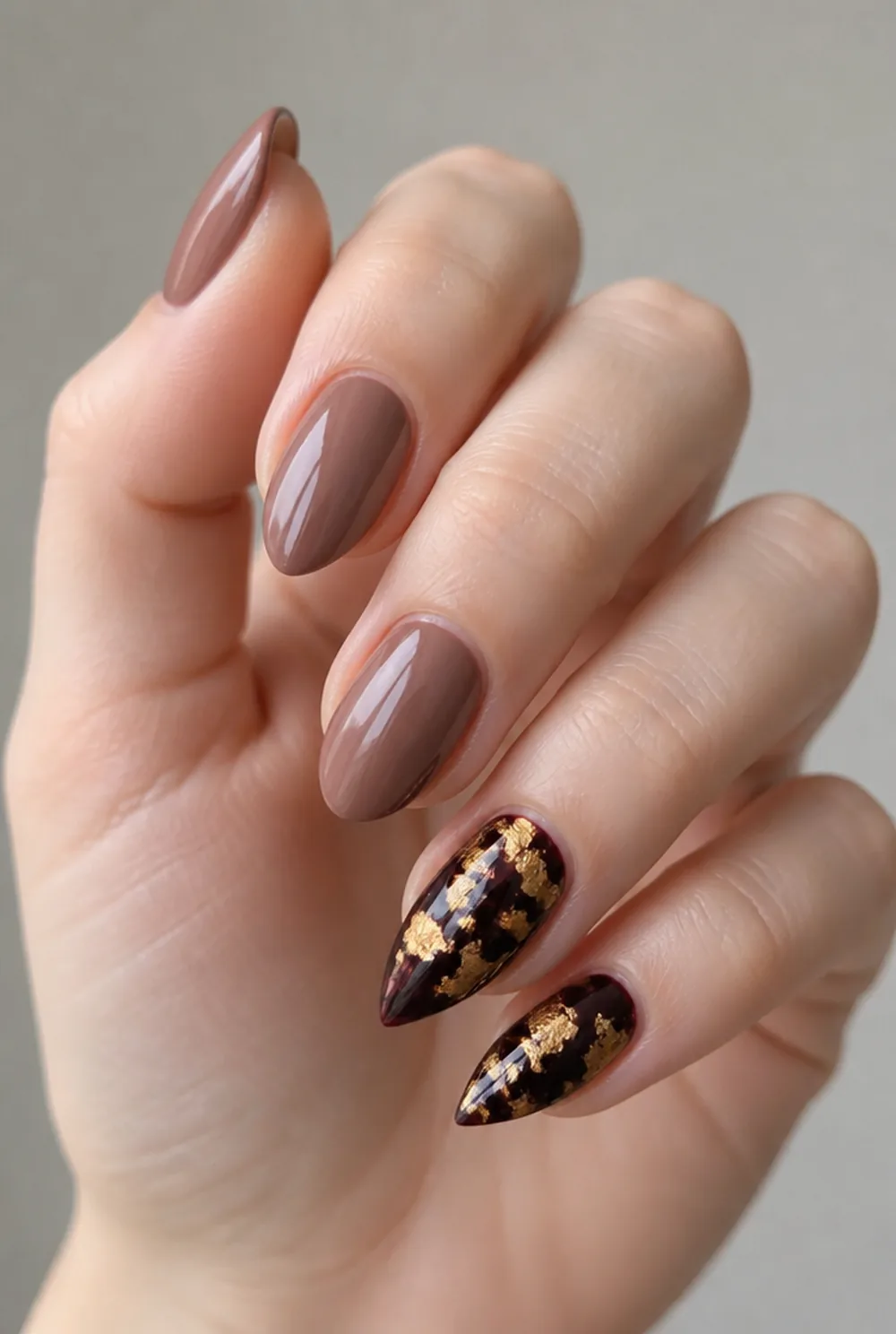 stiletto with gold foil nail art on fair skin, short length