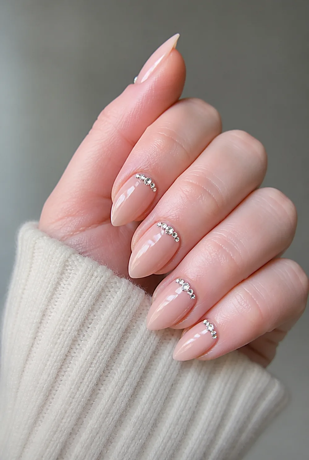 stiletto with rhinestone cuff nail art on fair skin, short length