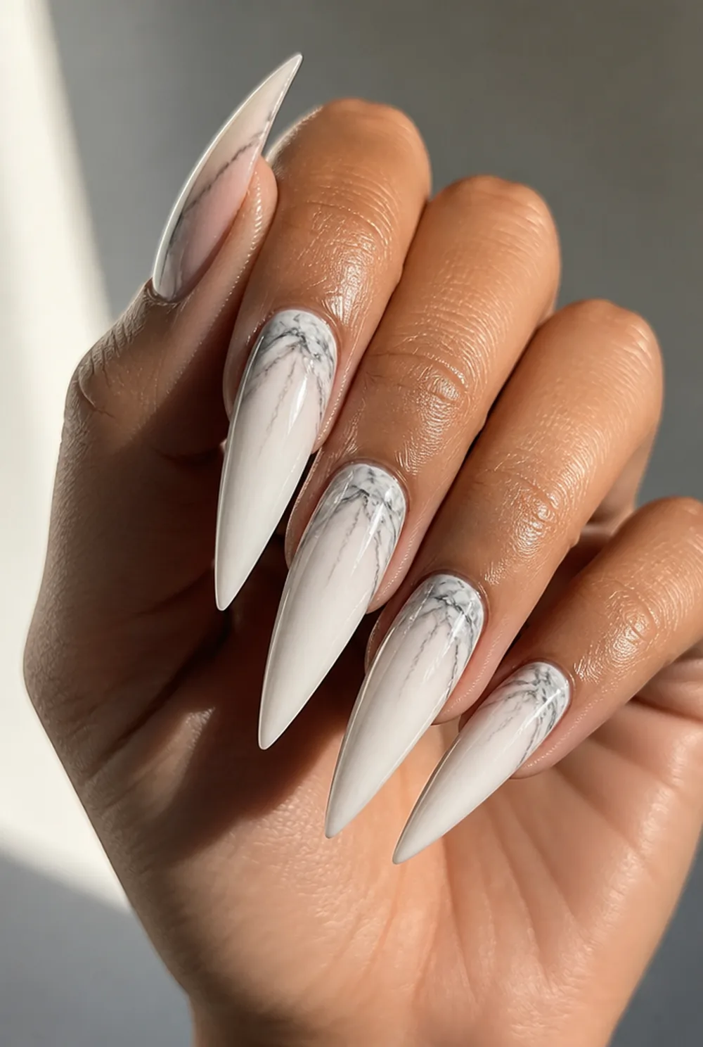 stiletto marble nail art on olive skin, long length