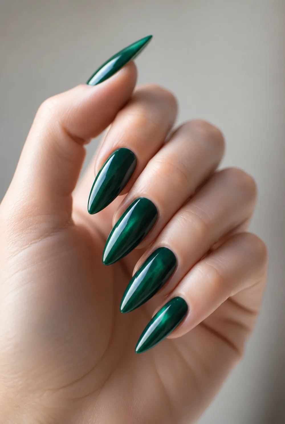 emerald stiletto nail art on fair skin, short length