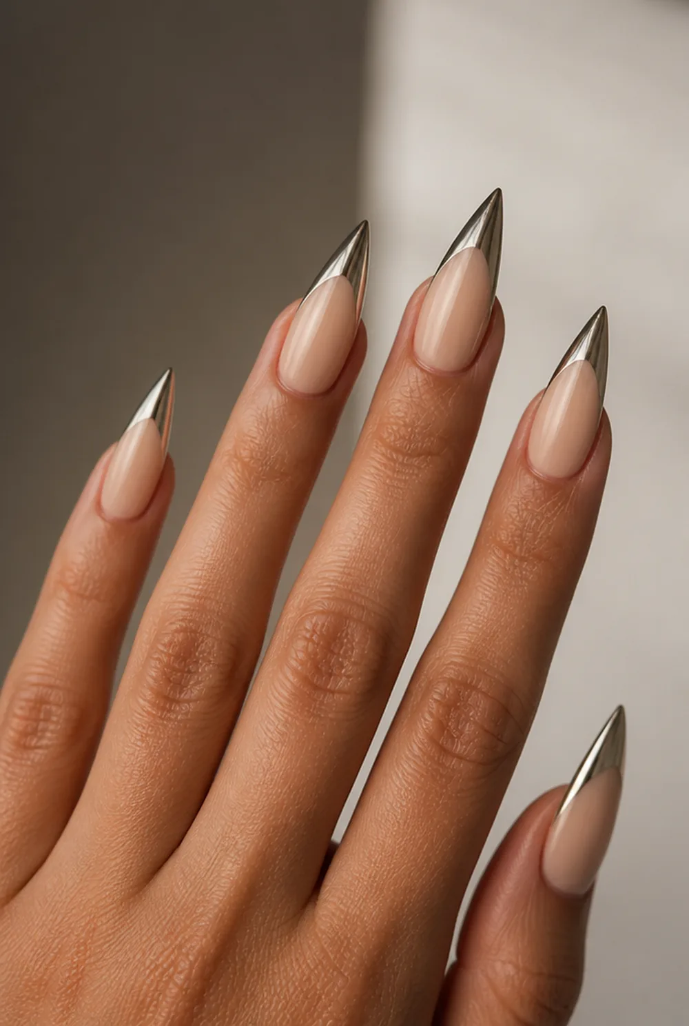 stiletto with chrome tips nail art on olive skin, long length