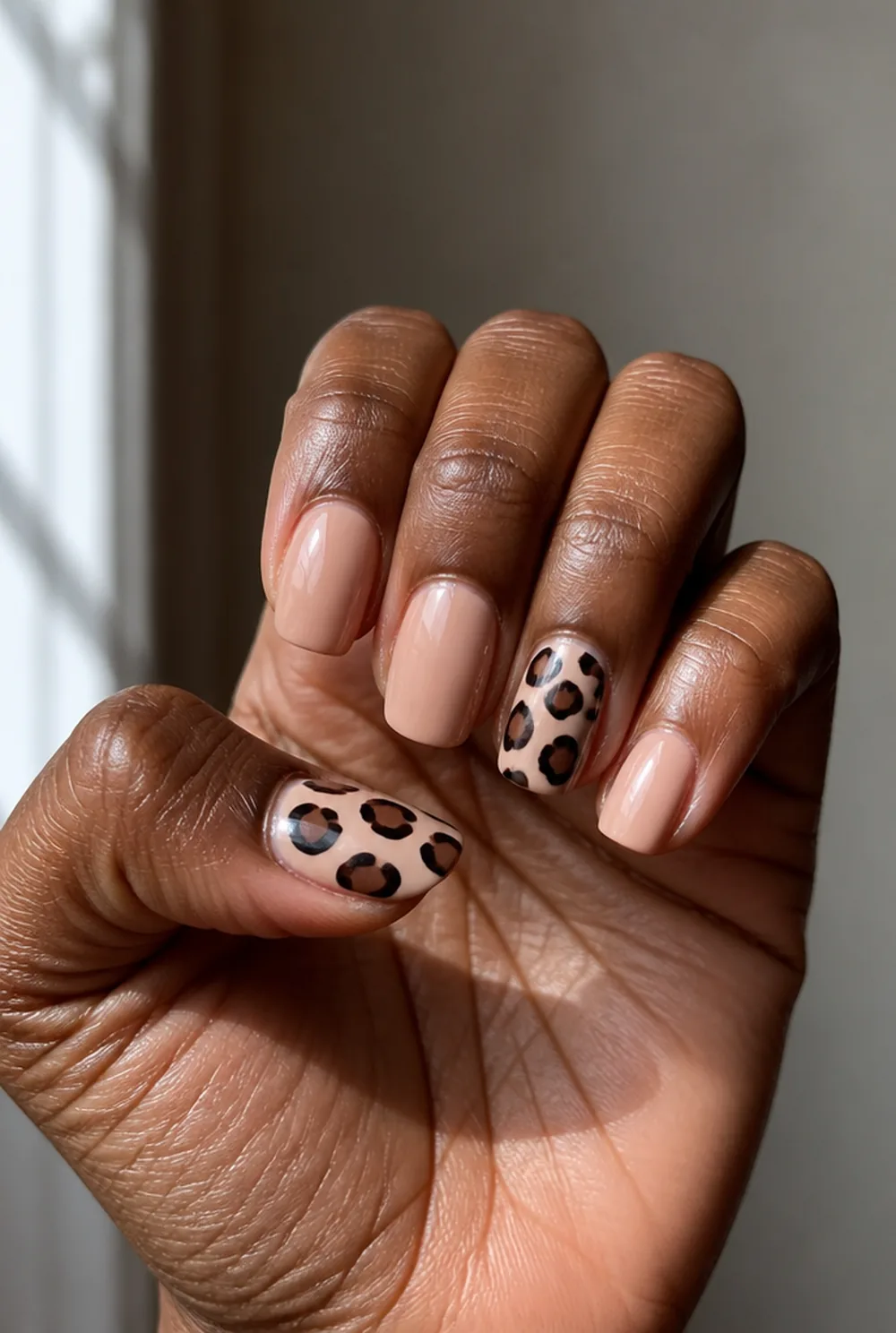 stiletto leopard accent nail art on deep brown skin