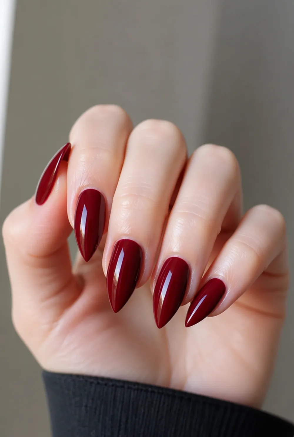 red stiletto nail art on fair skin, short length