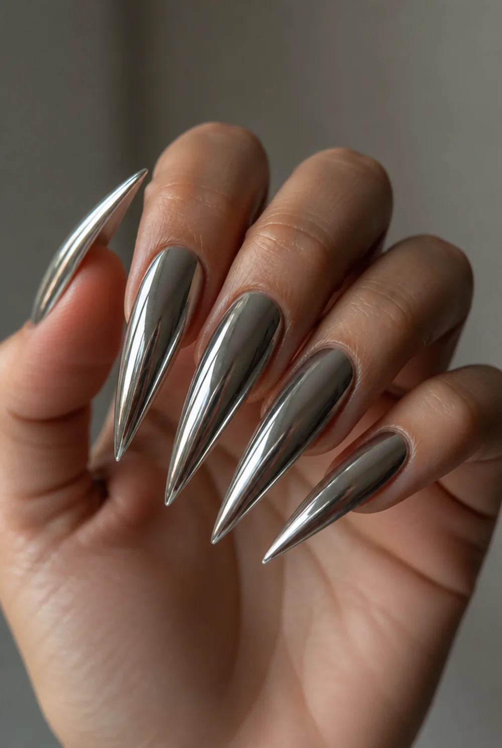 chrome stiletto nail art on olive skin, long length