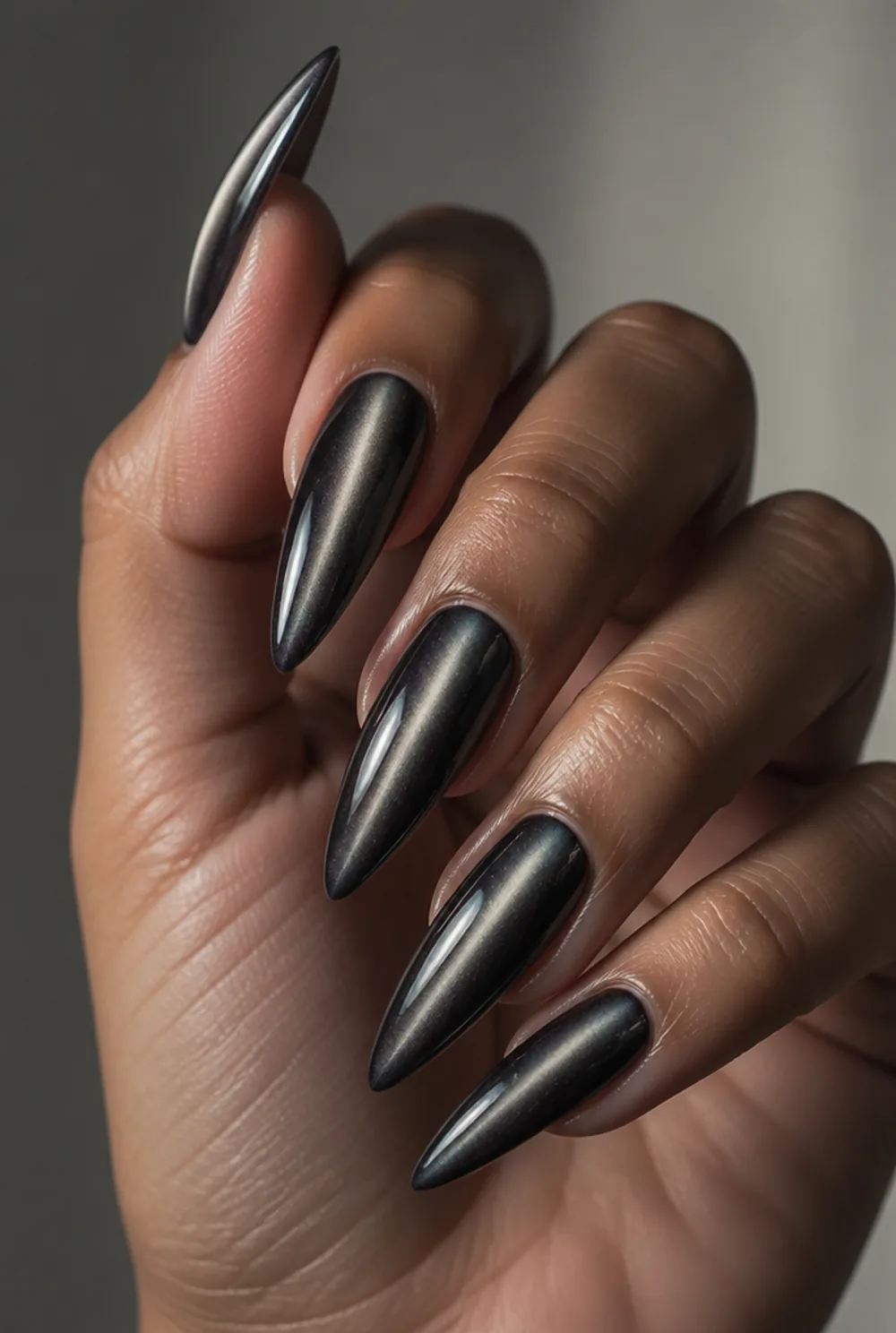 stiletto cat eye nail art on olive skin, long length