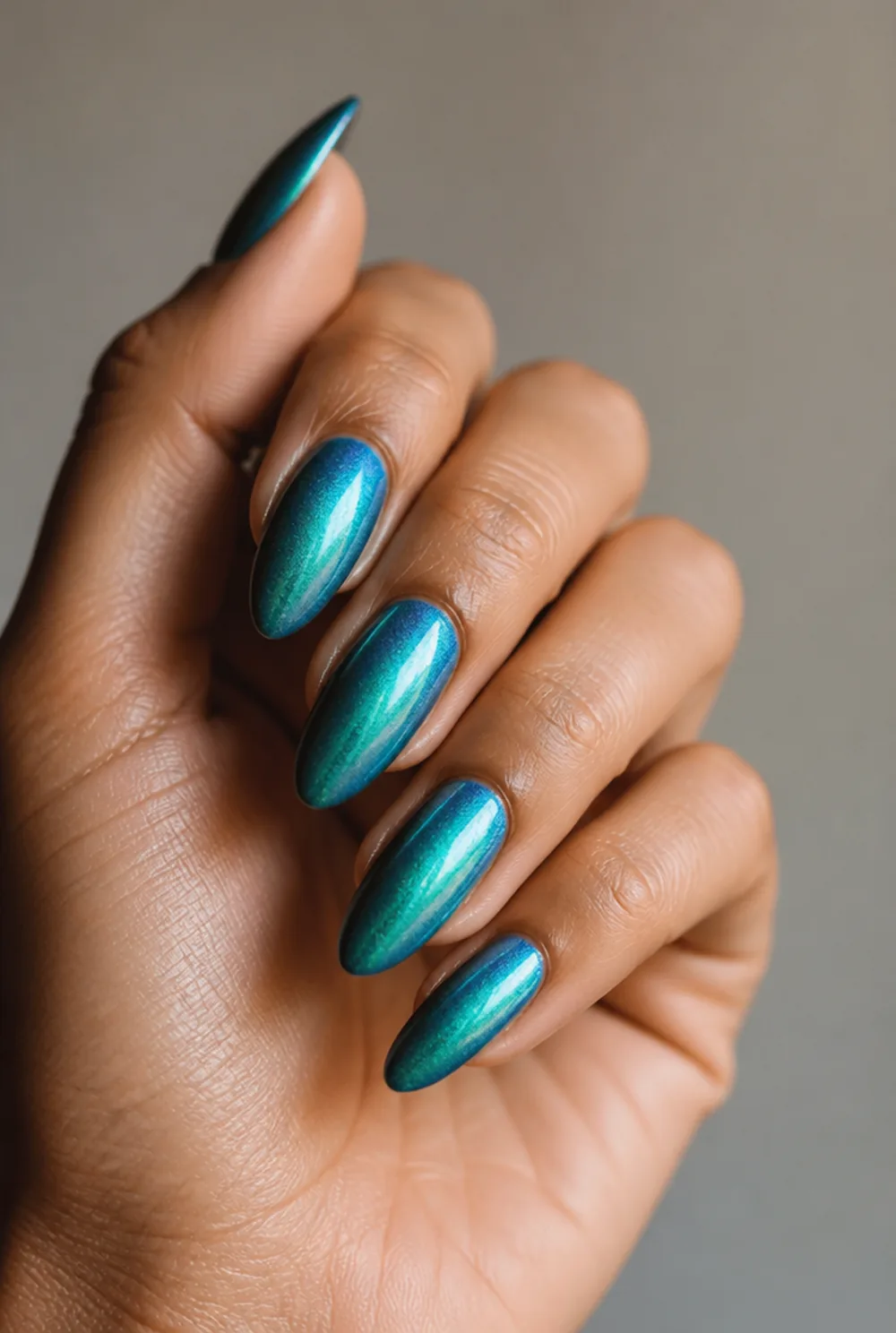 teal chrome nail art on olive skin, long length