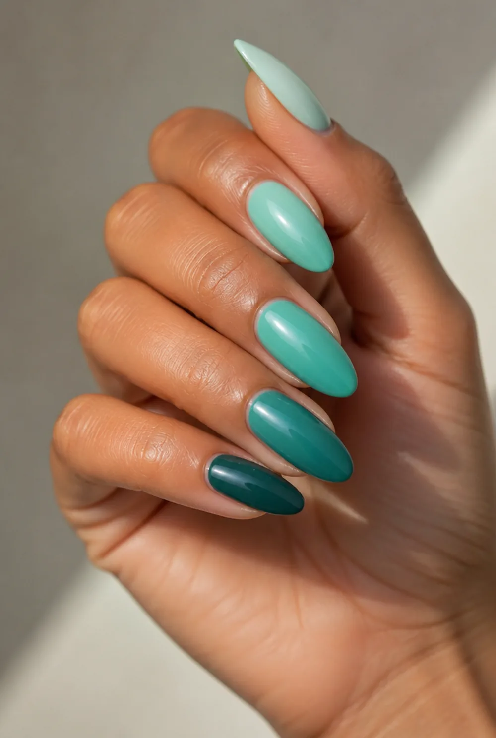 teal ombre nail art on olive skin, long length
