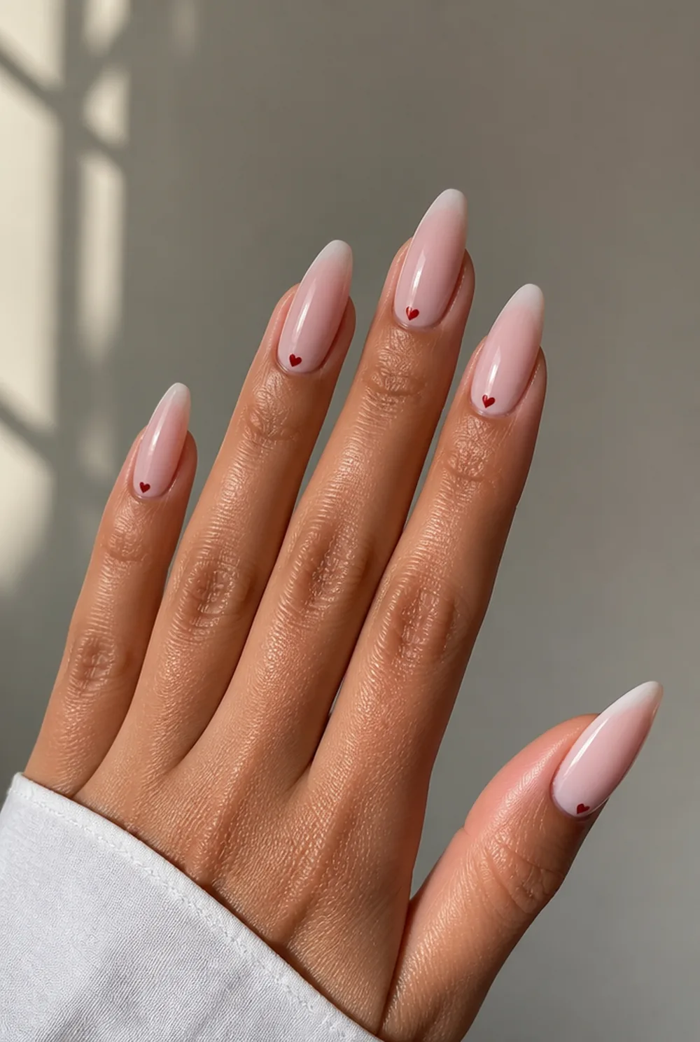 single tiny heart nail art on olive skin, long length