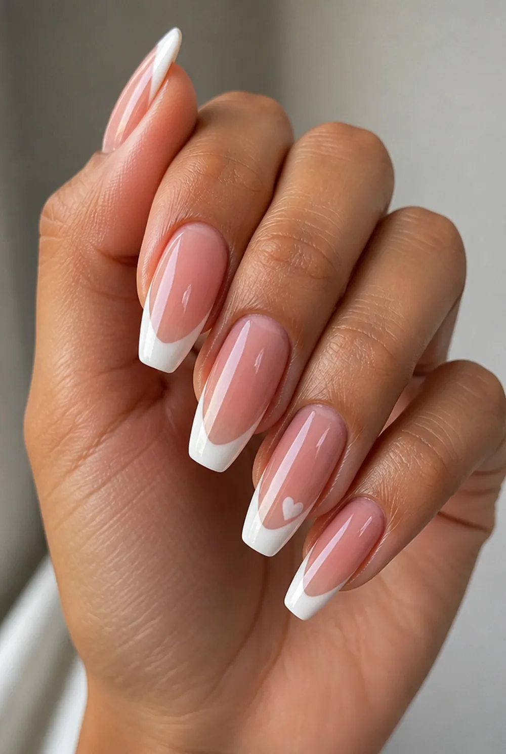 heart french tip nail art on olive skin, long length