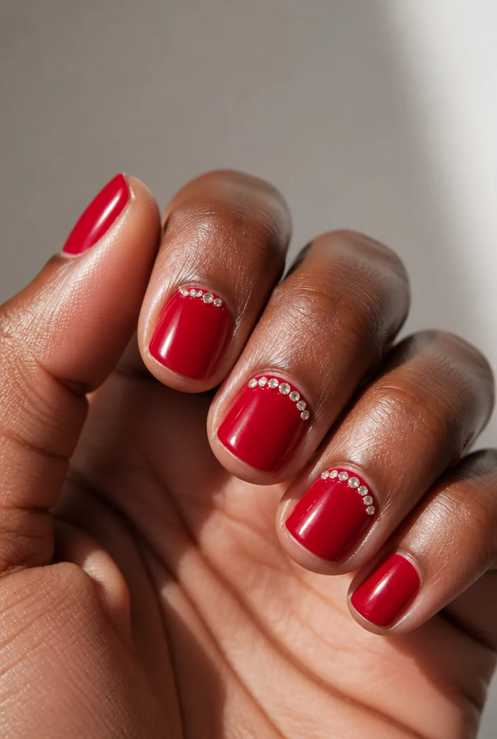 rhinestone cuff on red nail art on deep brown skin