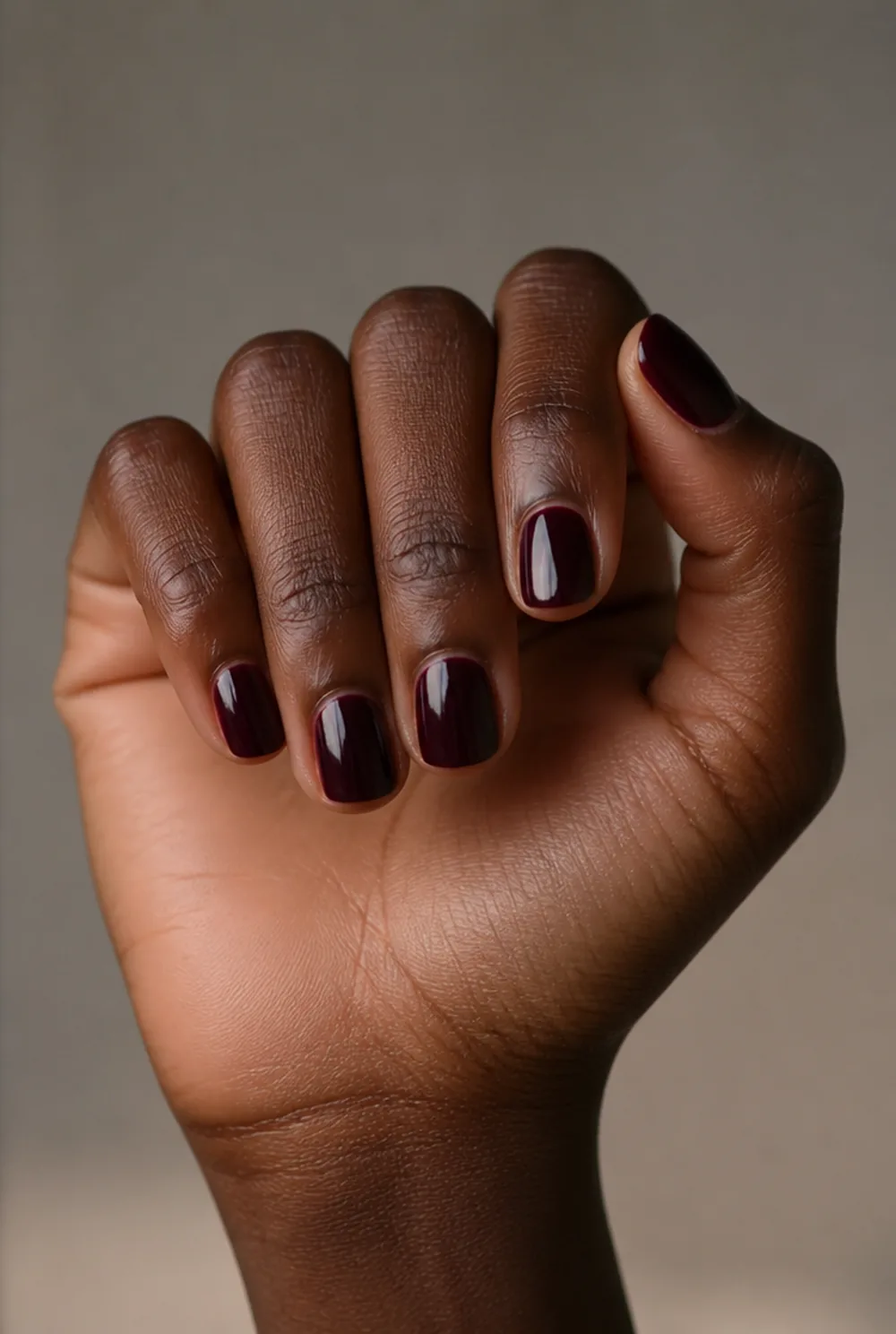 blackened cherry nail art on deep brown skin