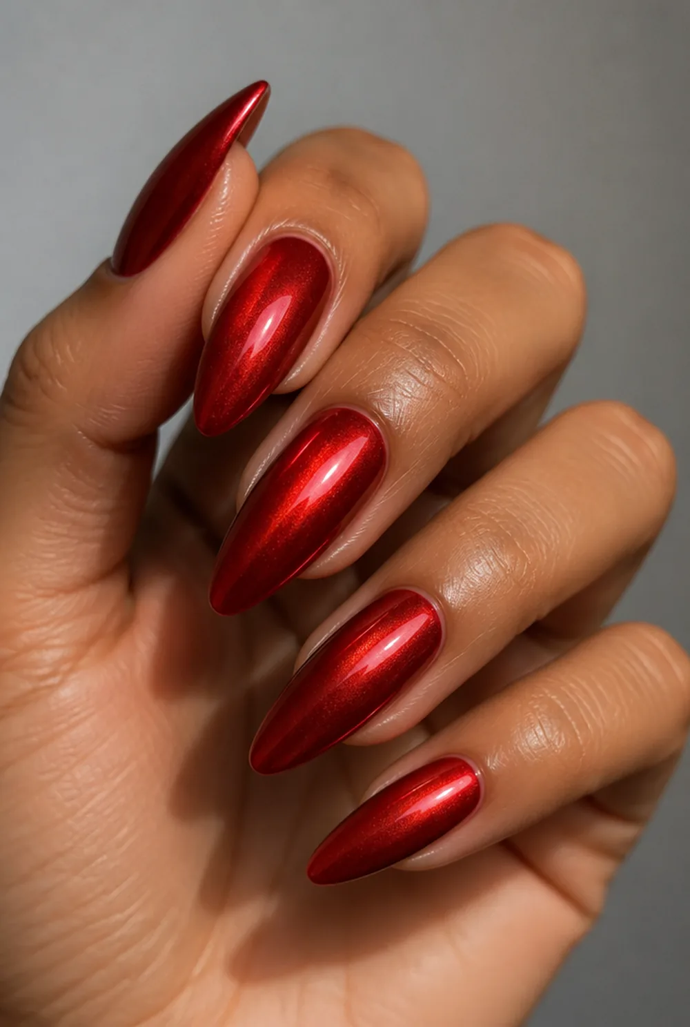 red chrome nail art on olive skin, long length