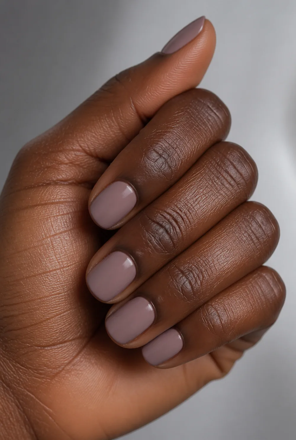 dusty rose nail art on deep brown skin