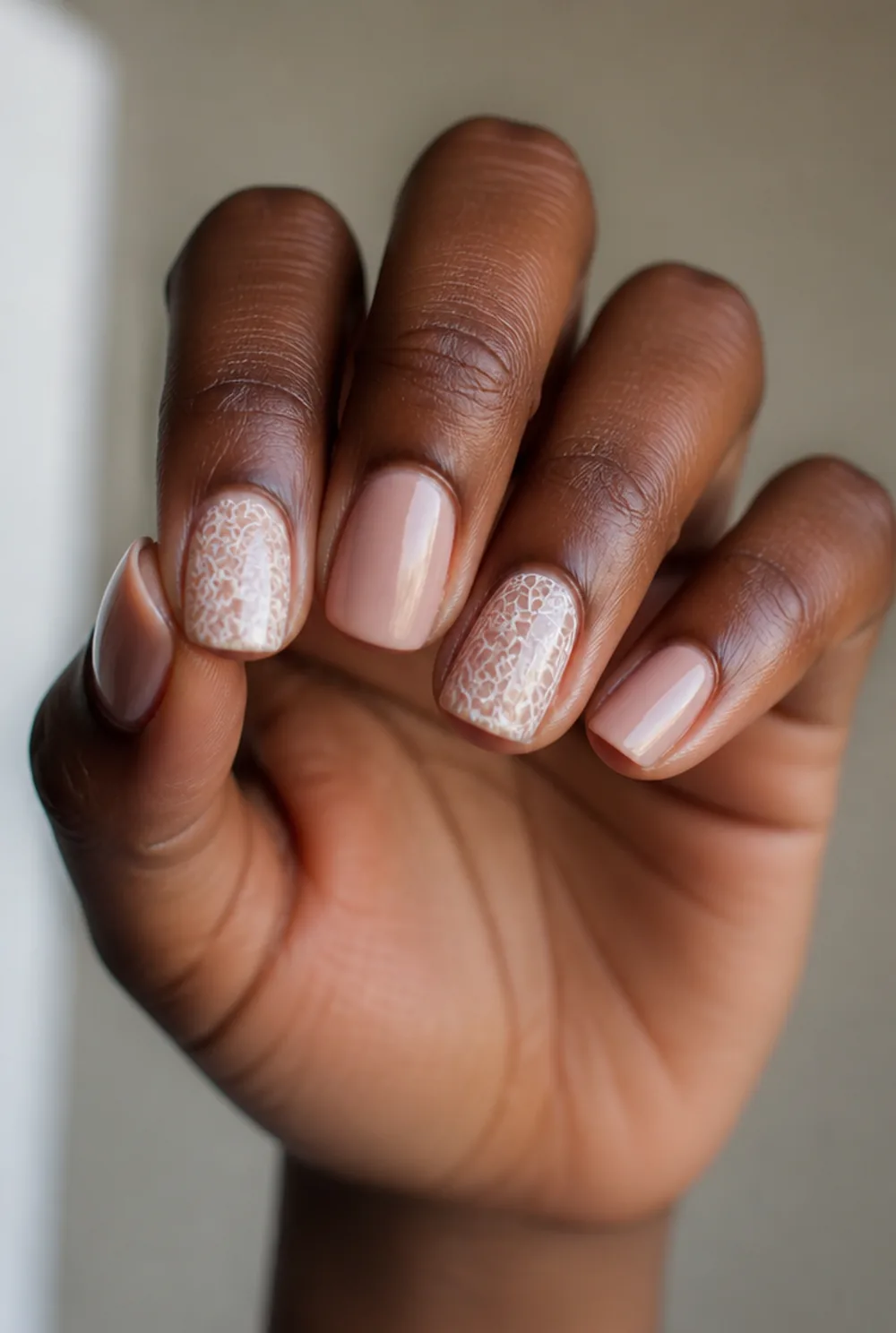 white lace nail art on deep brown skin
