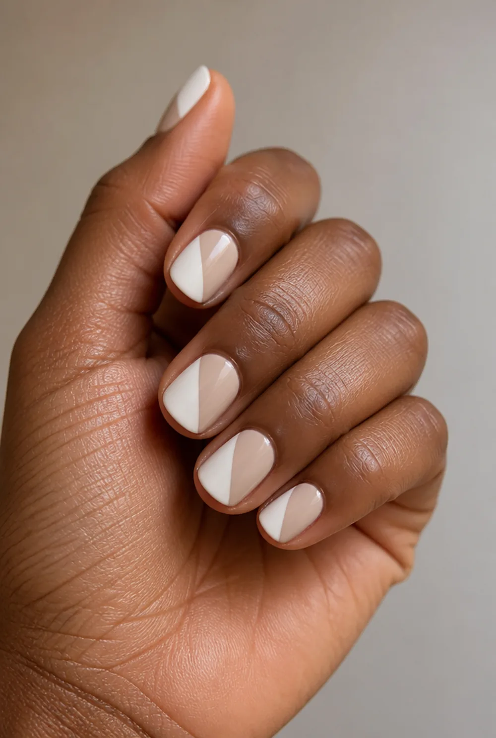 white and nude half and half nail art on deep brown skin