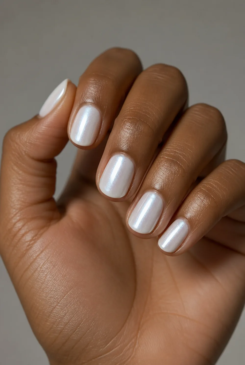white cat eye nail art on deep brown skin