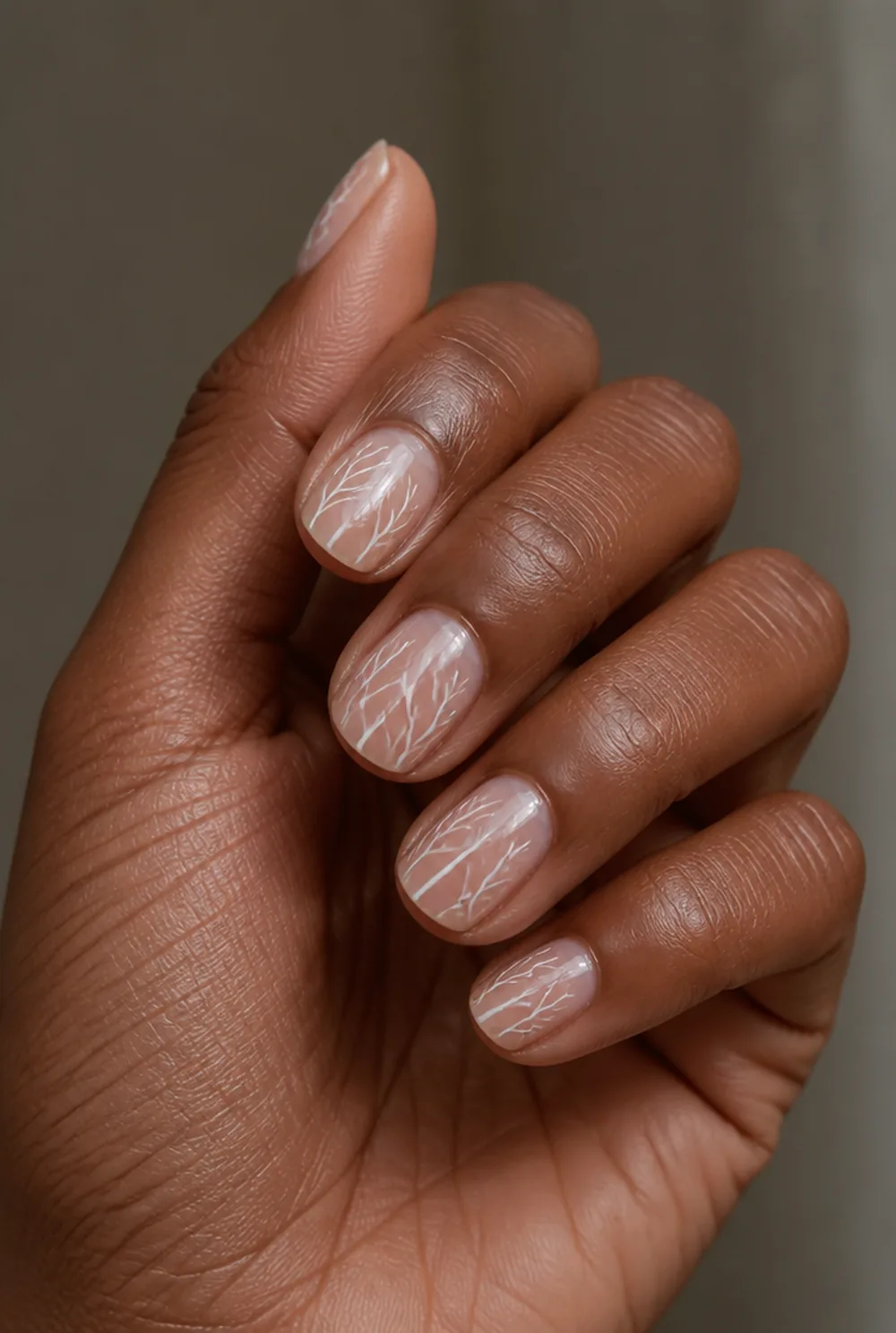 white frost lines nail art on deep brown skin