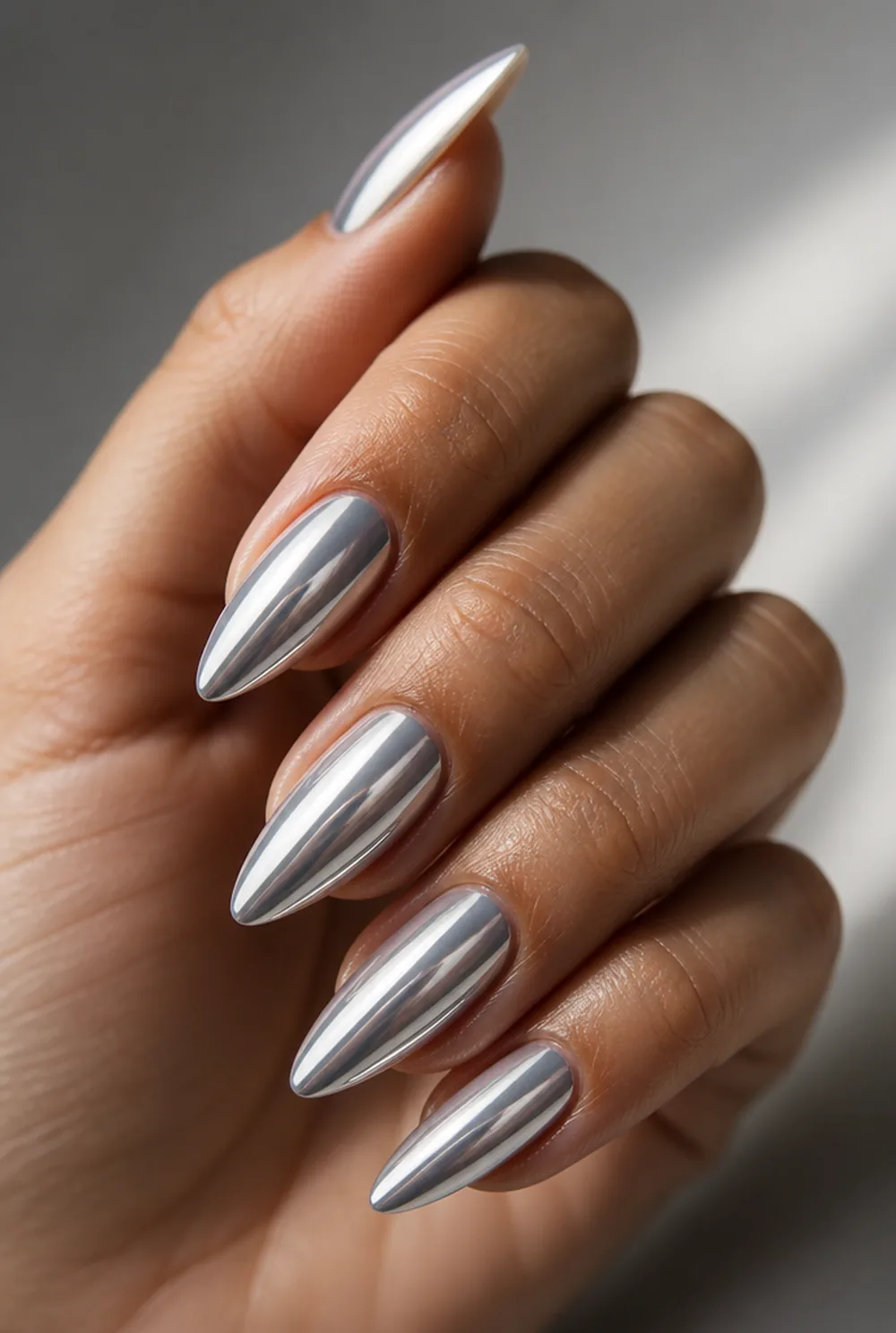 white chrome nail art on olive skin, long length