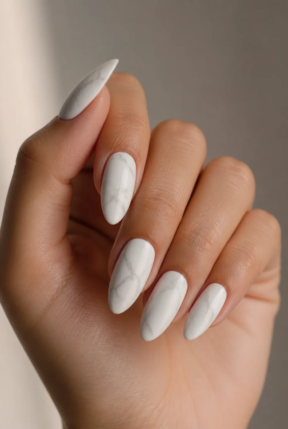 white marble nail art on olive skin, long length
