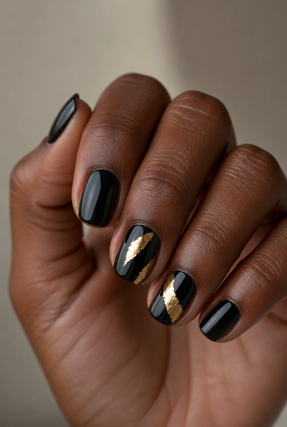 black and gold foil nail art on deep brown skin - PolishedAndPrettyNails.com black and gold foil nail art on deep brown skin