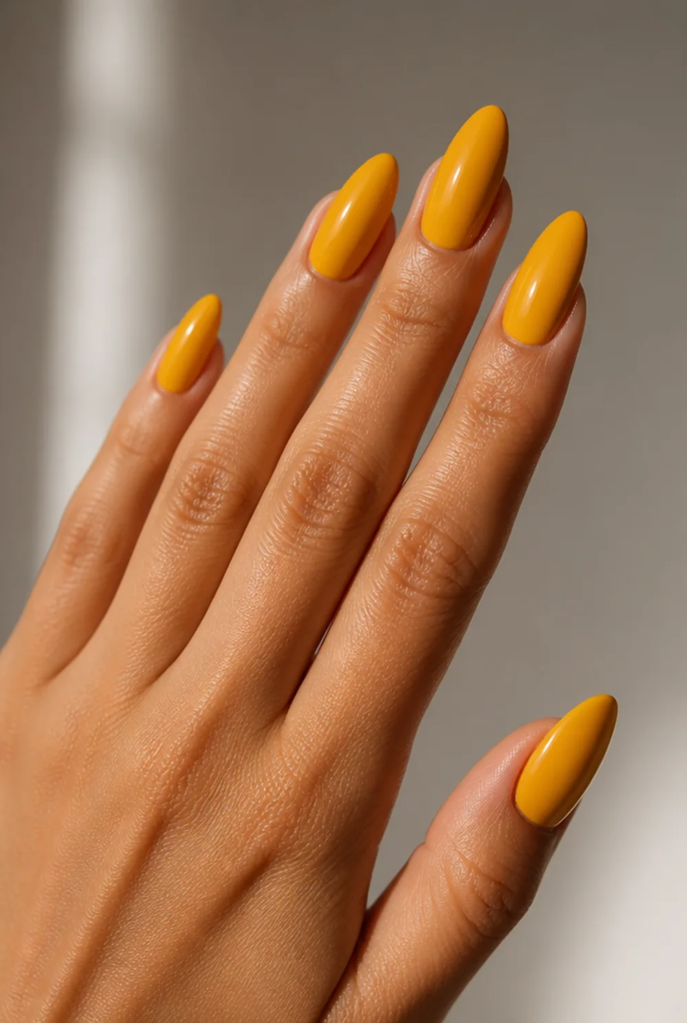 golden yellow nail art on olive skin, long length