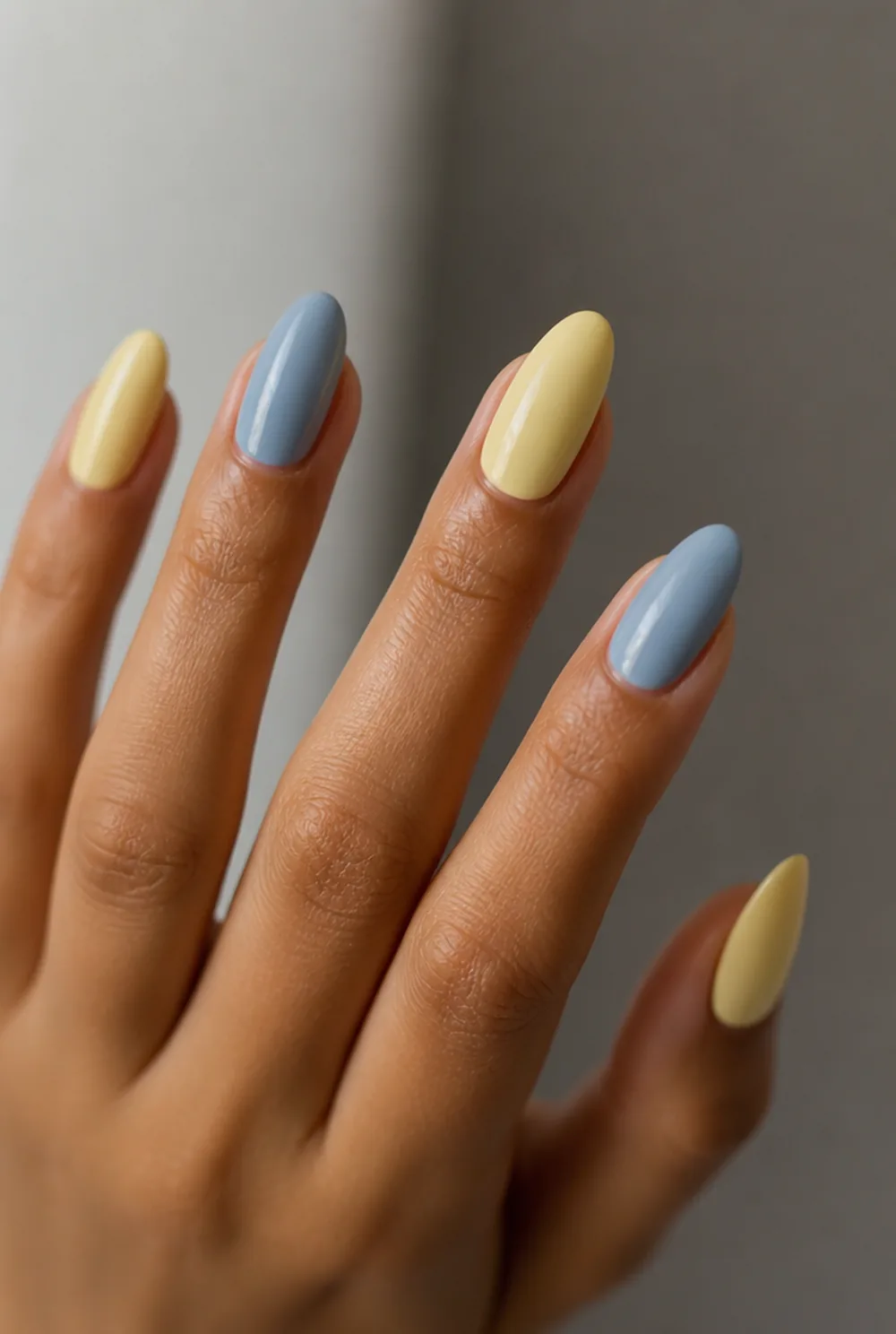 yellow and blue nail art on olive skin, long length