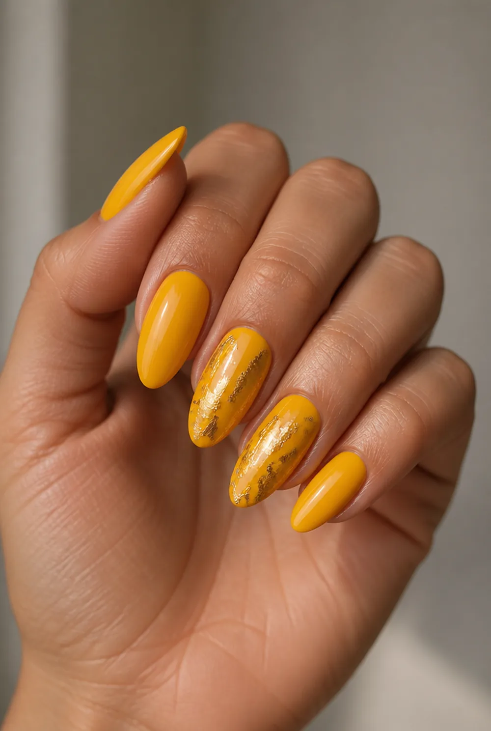 yellow with gold foil nail art on olive skin, long length