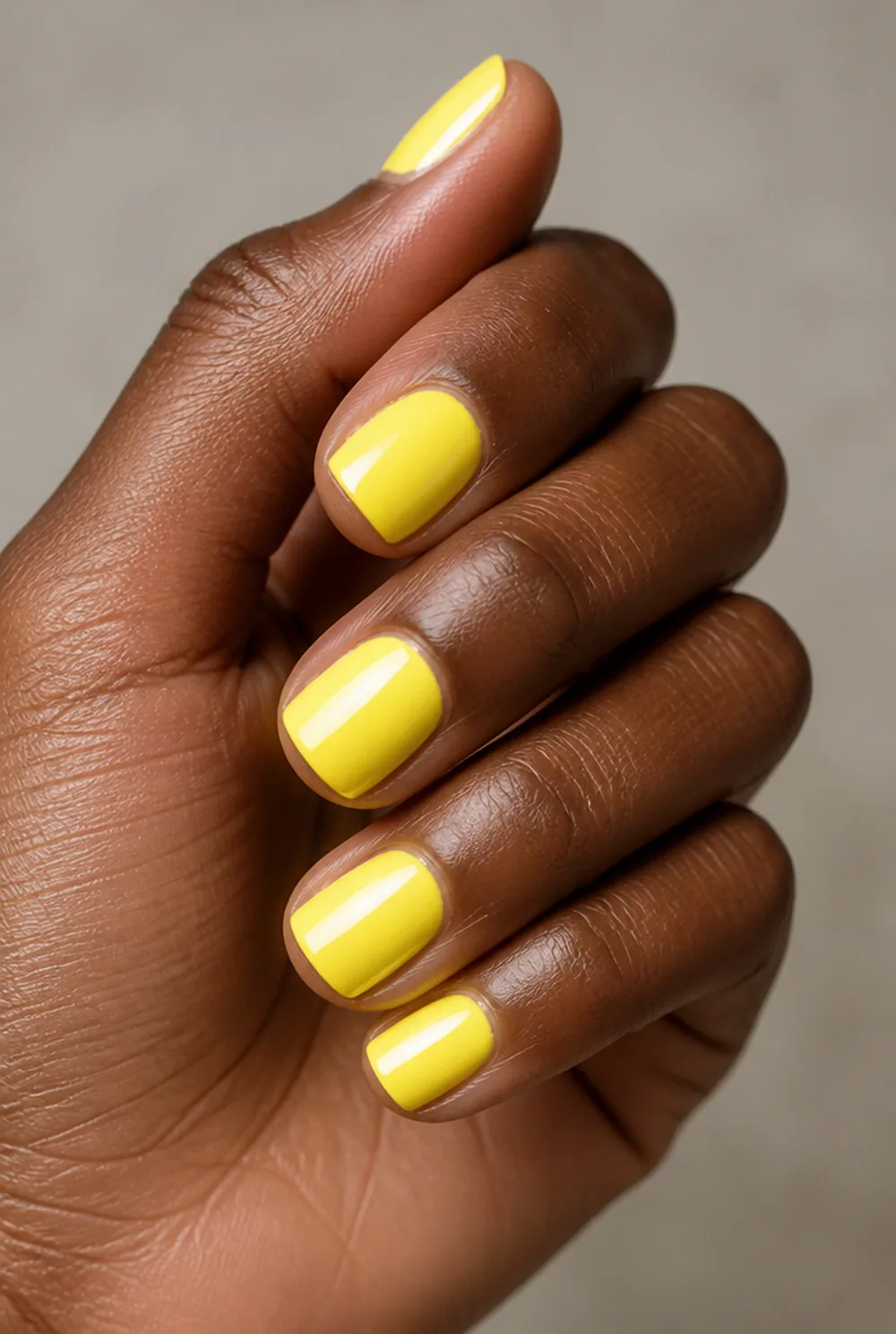 lemon nail art on deep brown skin