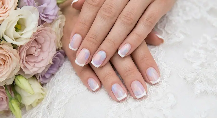 14wed - PolishedAndPrettyNails.com Watercolor wash French nails in pastel lilac and blue beside pink and lilac flowers