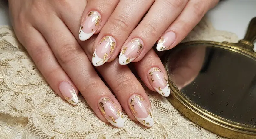 7wed - PolishedAndPrettyNails.com Vintage-inspired gold leaf French nails on lace beside an antique gold hand mirror