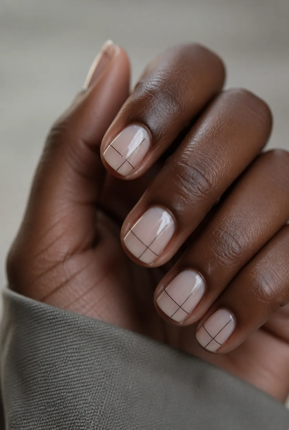 crossed lines nail art on deep brown skin