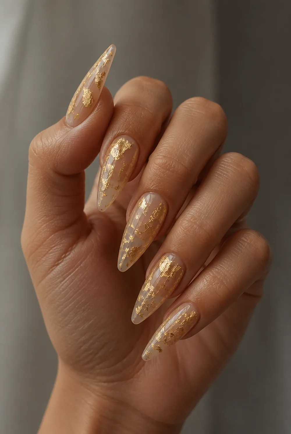 abstract gold leaf nail art on olive skin, long length
