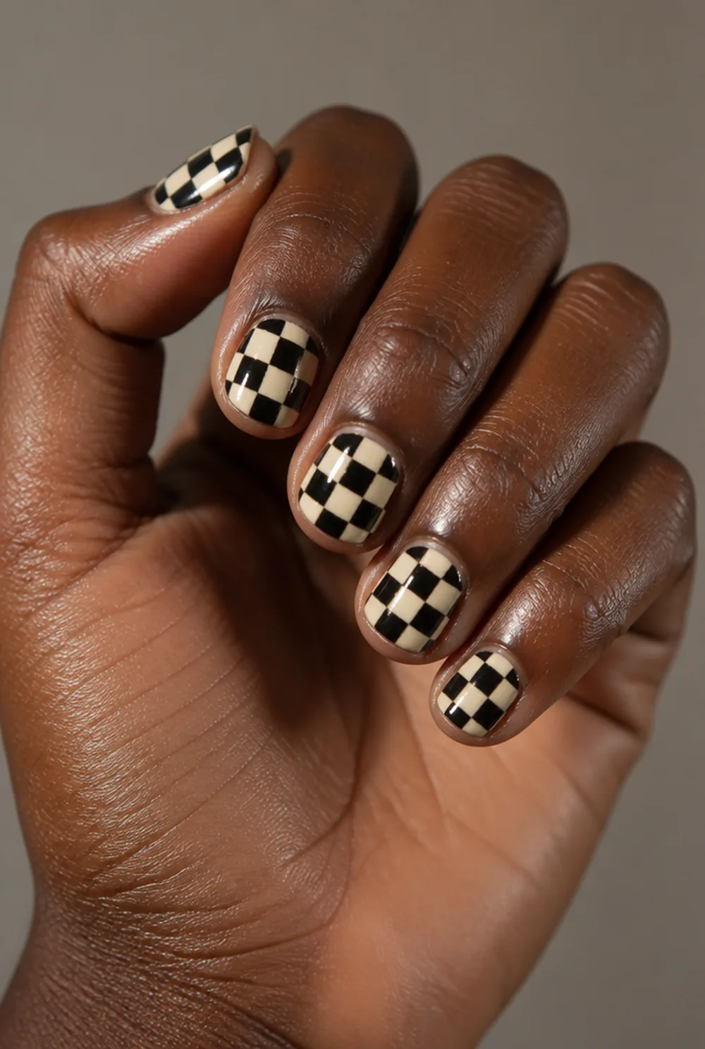 abstract checkerboard nail art on deep brown skin
