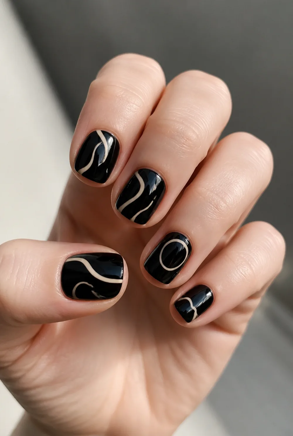 abstract on black nail art on fair skin, short length