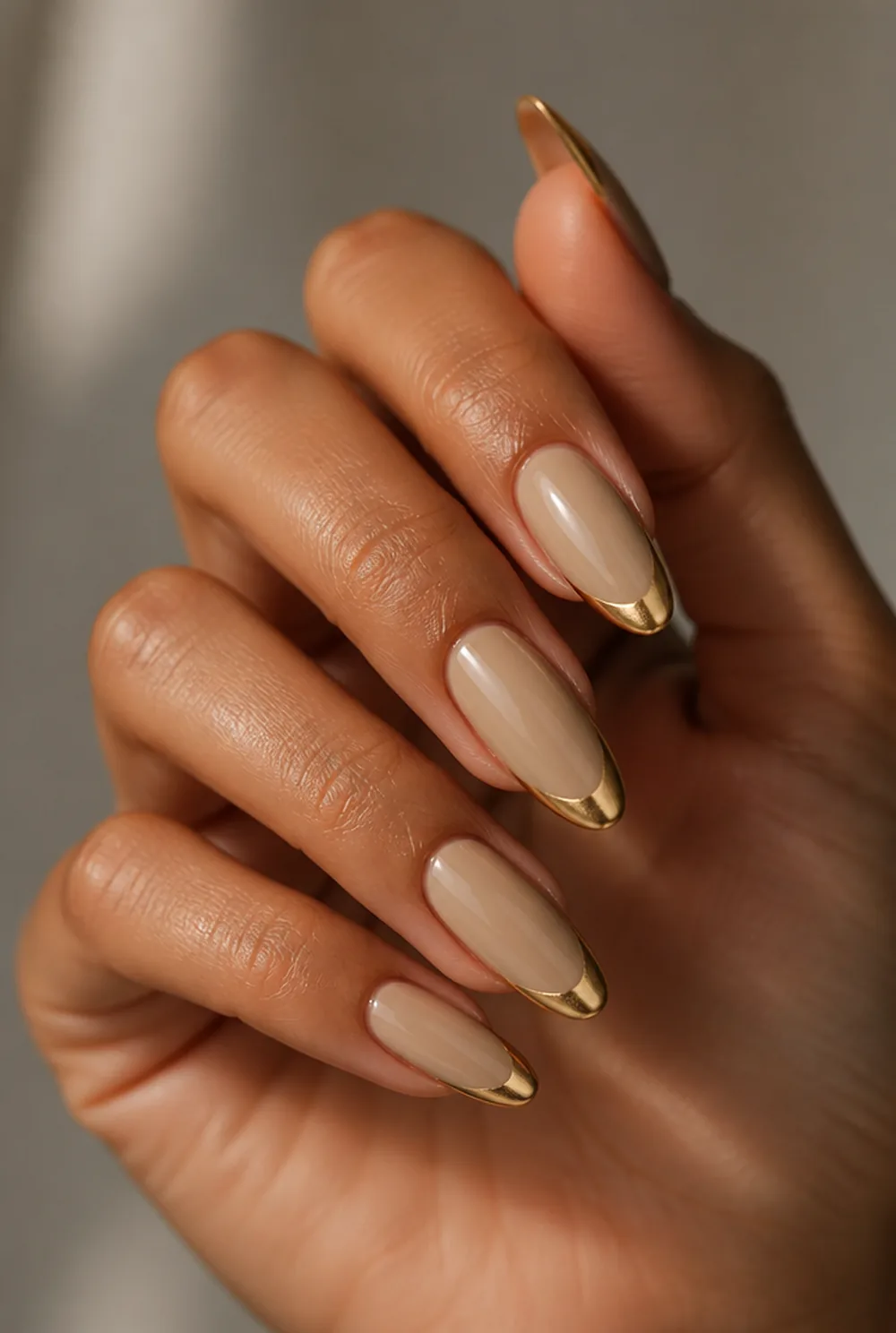 gold chrome french nail art on olive skin, long length