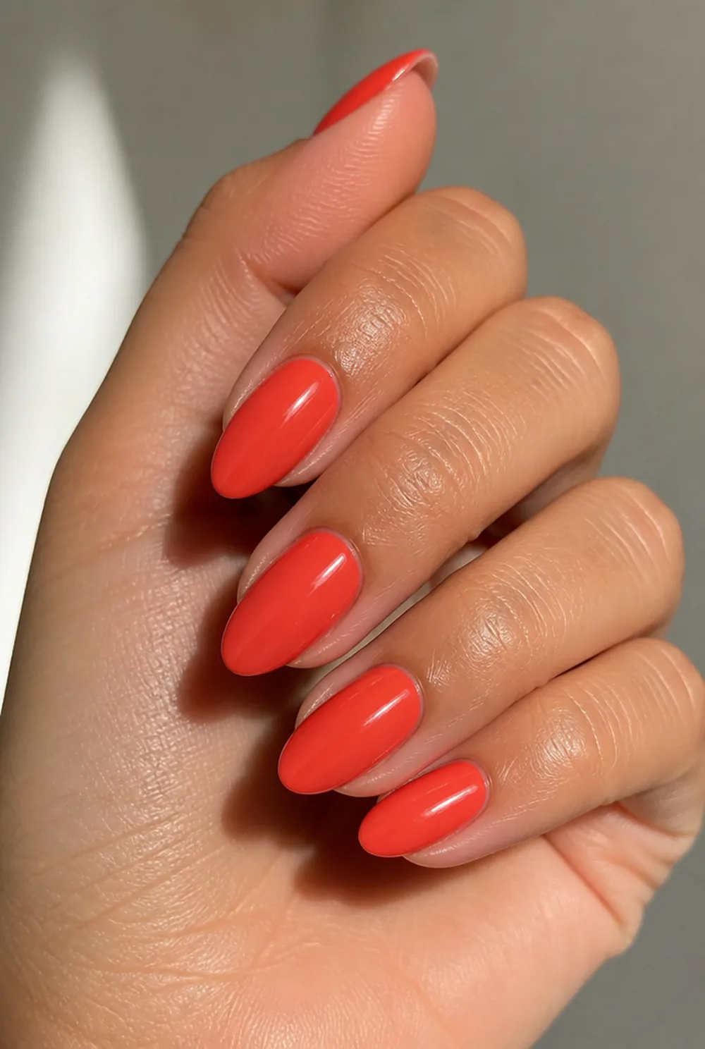 classic coral creme nail art on olive skin, long length