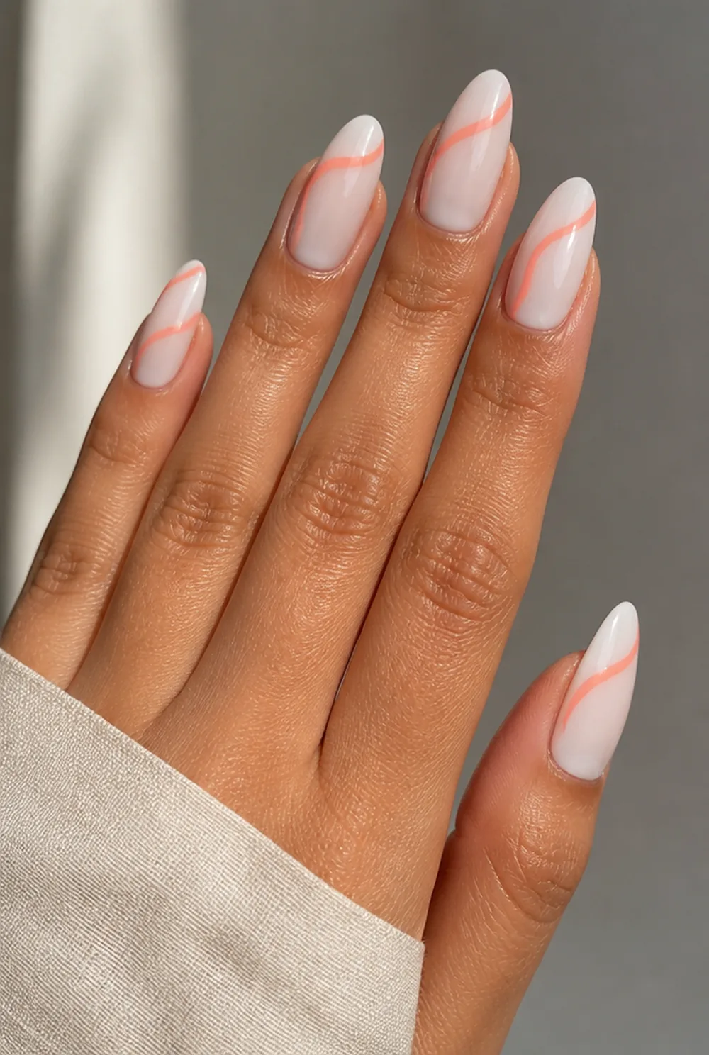 coral swirl nail art on olive skin, long length