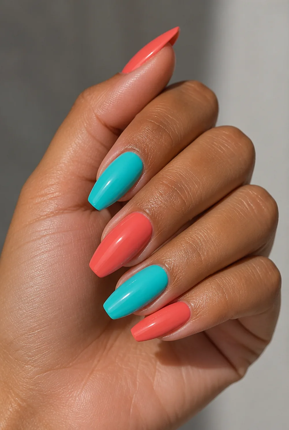 coral and turquoise nail art on olive skin, long length
