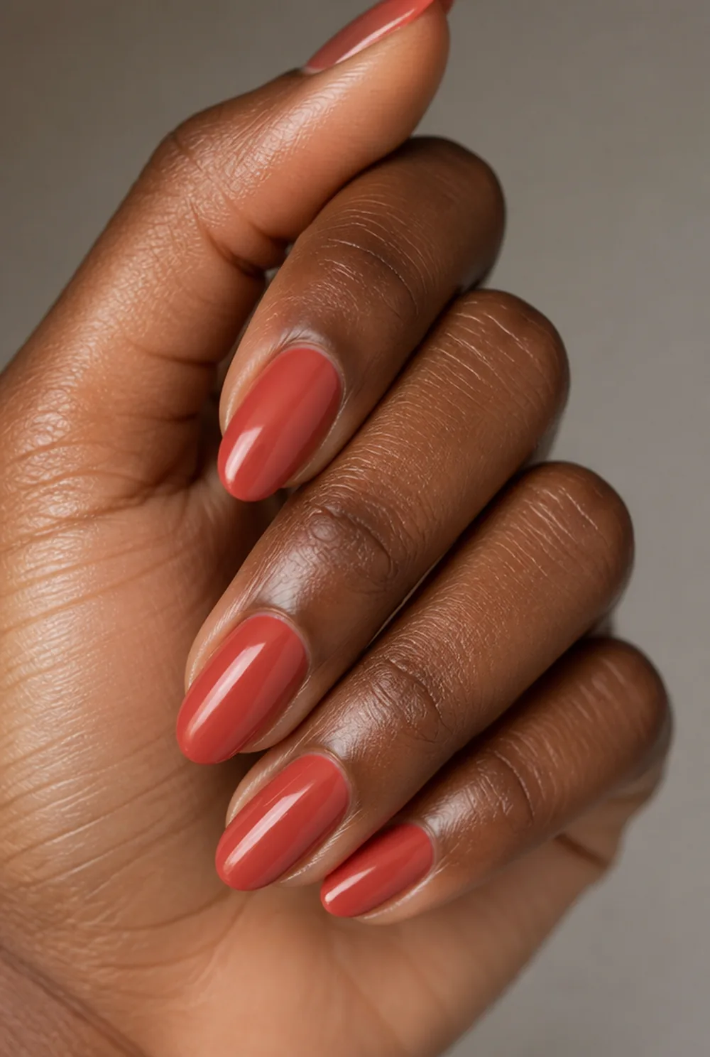 deep coral nail art on deep brown skin