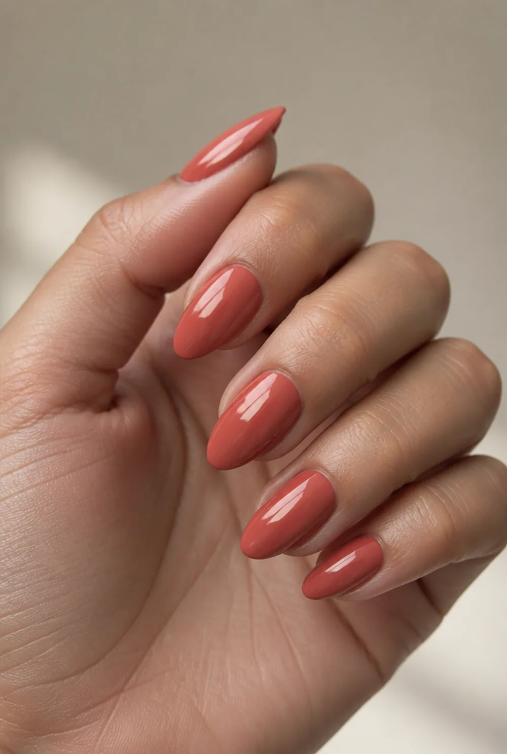 deep coral nail art on olive skin, long length
